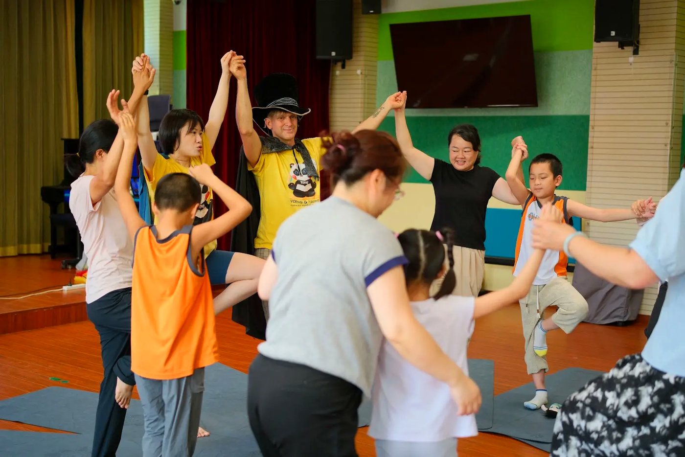 Rainbow Yoga trainees smiling together after a playful group learning experience