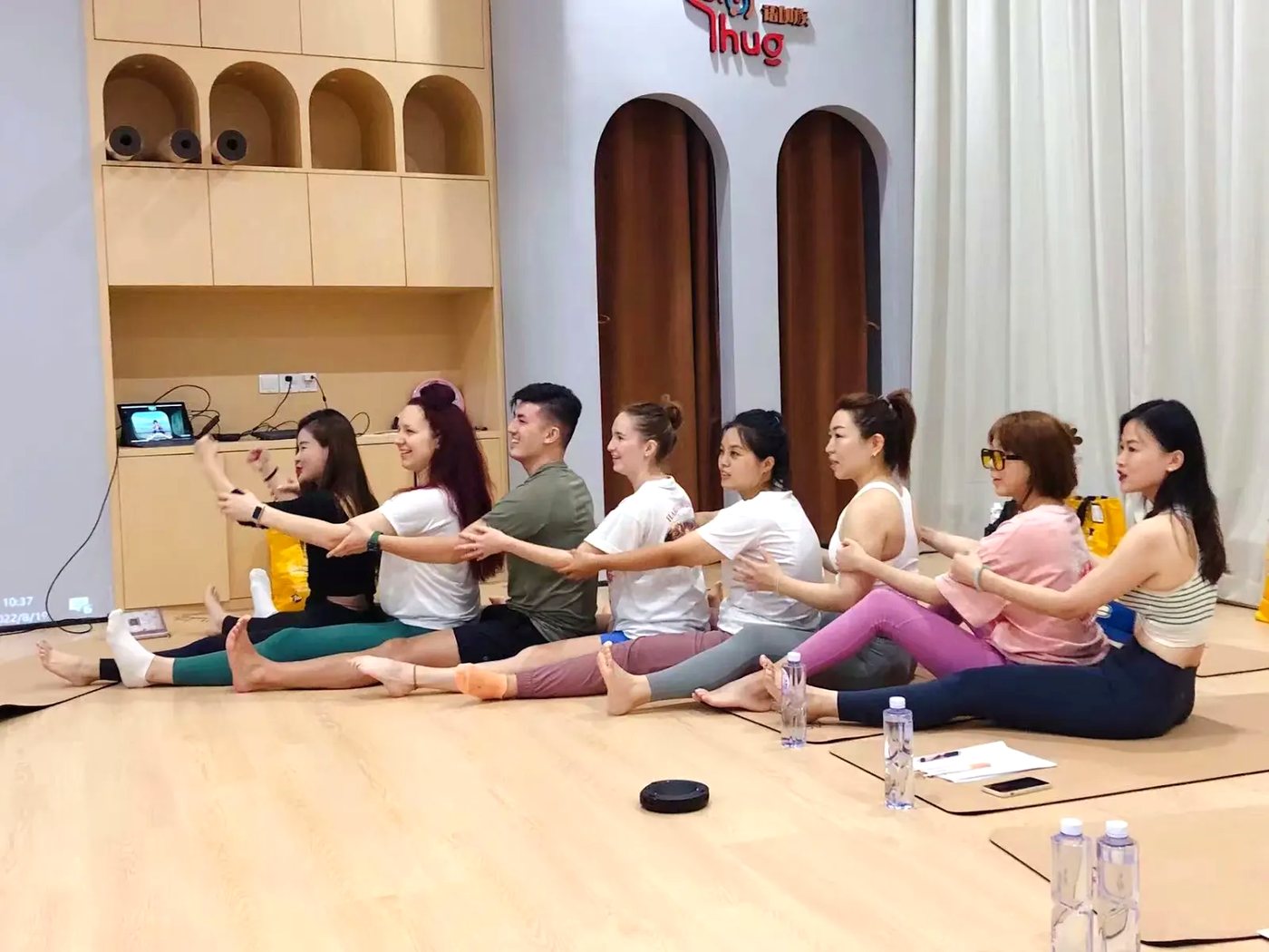 Rainbow Yoga trainees practicing a connected partner chain
