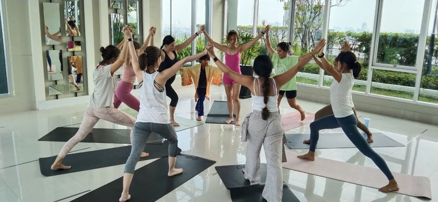 Students connecting through Rainbow Yoga activities in Thailand