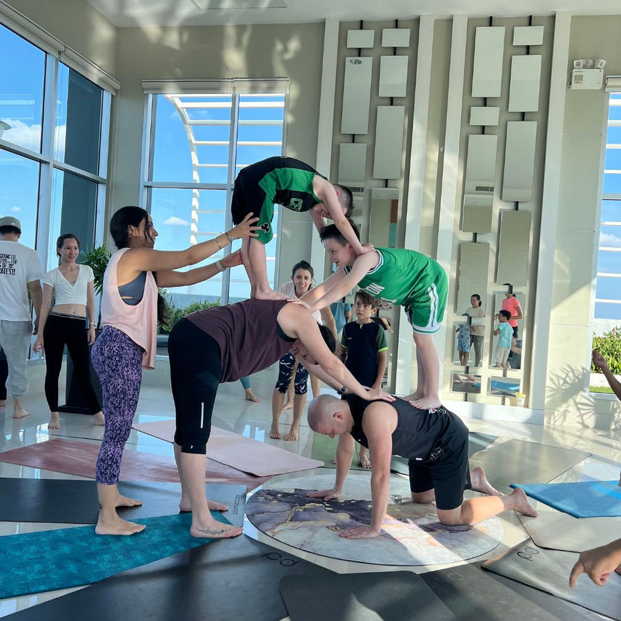 Rainbow Yoga trainees practicing joyful group activities in Bangkok