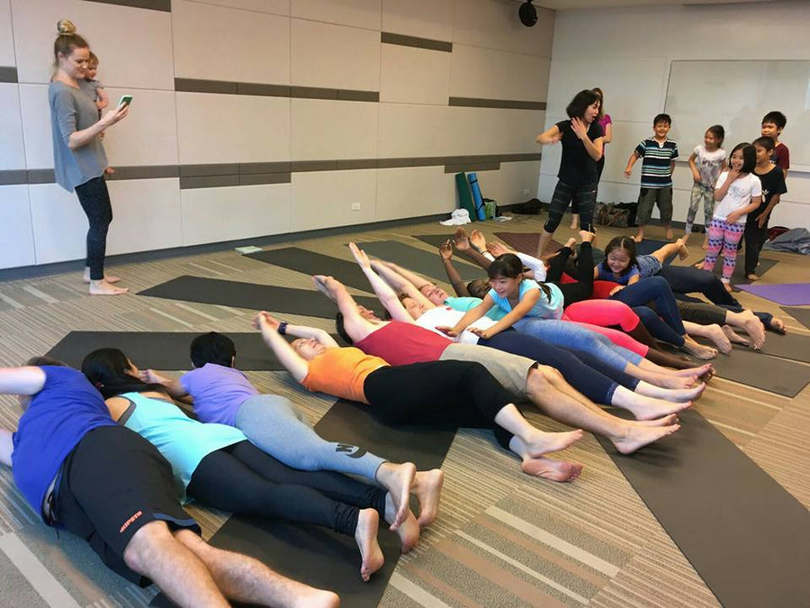 Kids yoga teacher trainees learning playful partner yoga in Thailand