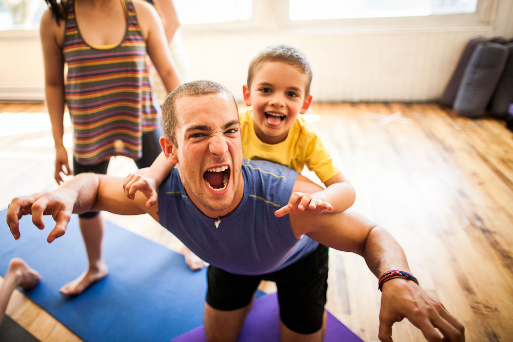 Rainbow Yoga students practising a joyful partner yoga pose