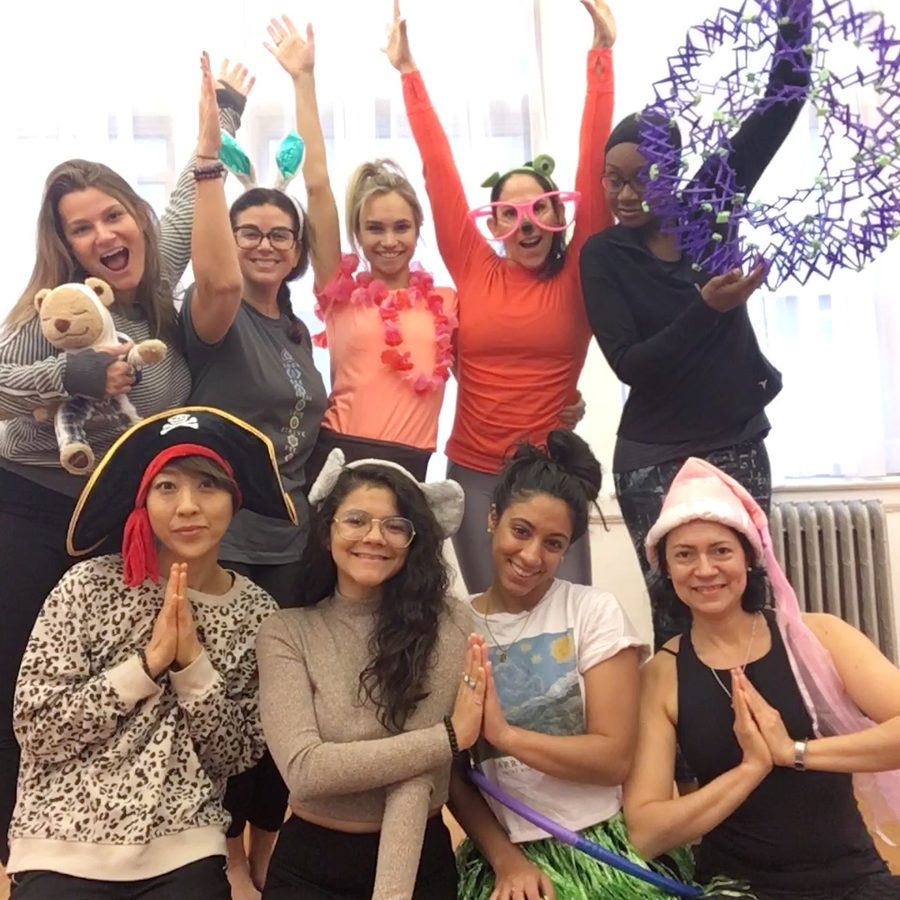 A diverse group of Rainbow Yoga trainees celebrating together