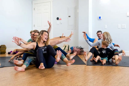 A child smiling during a joyful Rainbow Yoga activity