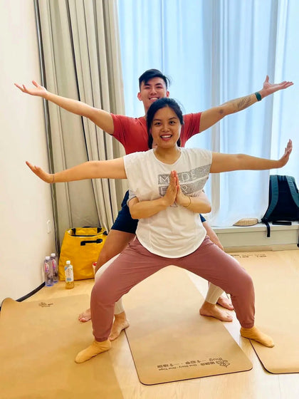 Rainbow Yoga trainees creating a connected human mandala shape